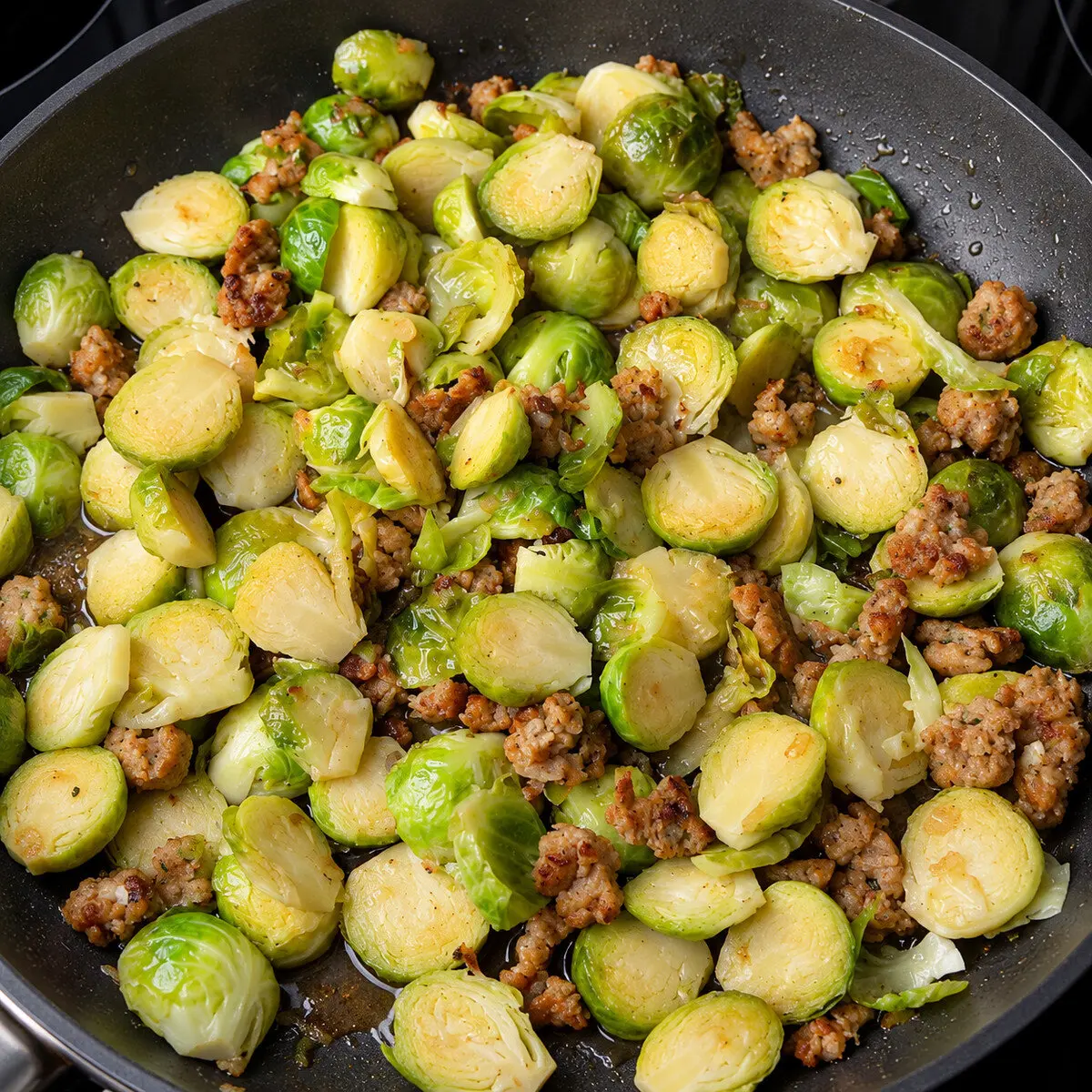 Preparation step for Sliced Brussels Sprouts with Italian Sausage.